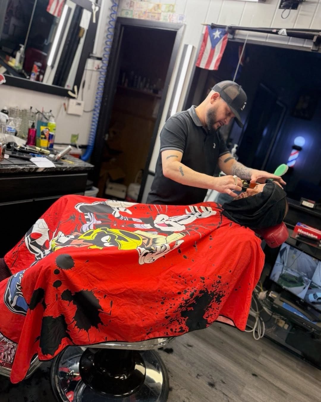 Barber giving a reclined client a straight-razor shave